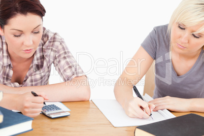 Pretty students learning at table