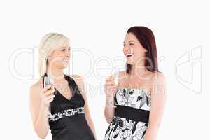 Smiling well-dressed women drinking champaign
