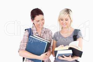 Female students reading a book