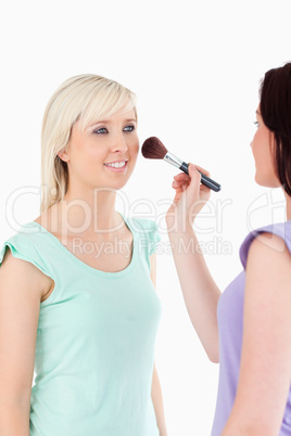 Charming Women applying make-up