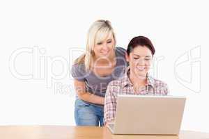 Portrait of joyful women with a laptop