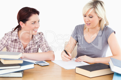 Student explaining homework to friend