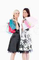 Joyful well-dressed women with shopping bags