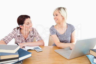 Cute women learning at table