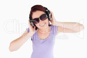 Red-haired Woman with headphones and sunglasses