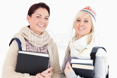 Female students with books looking