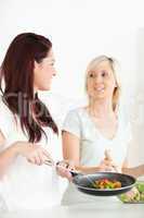 Cute Women cooking dinner