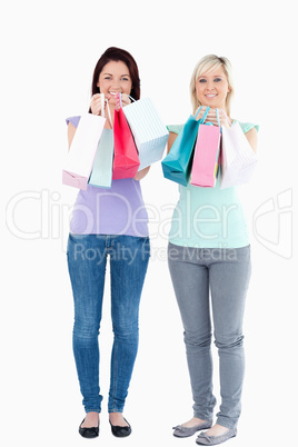 Charming women with shopping bags