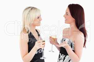 Cute well-dressed women drinking champaign