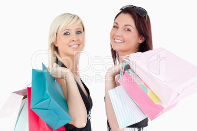 Cute well-dressed women with shopping bags