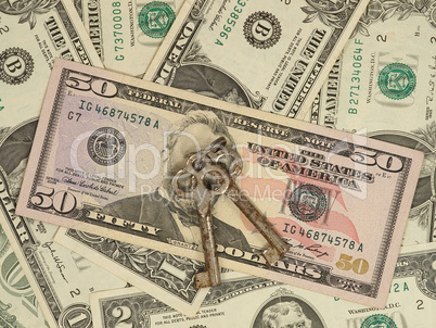 Metal keys on a dollar banknotes.