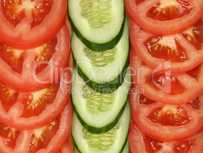 Slices of tomato and cucumber as background.