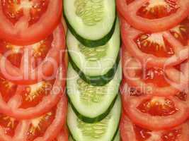 Slices of tomato and cucumber as background.