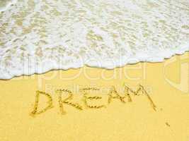dream word written in the sandy beach