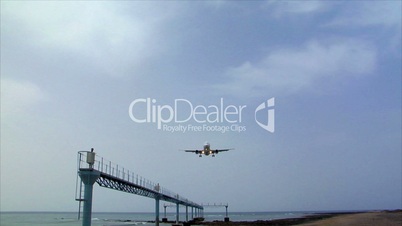 airplane landing over seaside audio