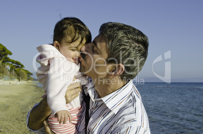 Baby with her Father on the Beach
