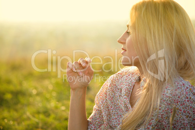 Girl is relaxing on green field