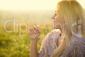 Girl is relaxing on green field