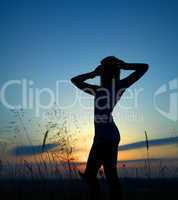 Silhouette of a girl over sunset
