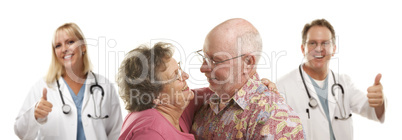 Senior Couple with Medical Doctors or Nurses Behind