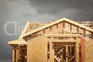 Home Construction Framing with Ominous Clouds