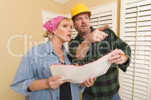 Contractor in Hard Hat Discussing Plans with Woman