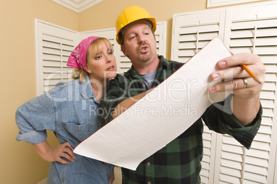 Contractor in Hard Hat Discussing Plans with Woman