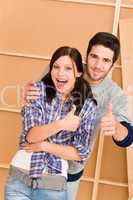 Home improvement young happy couple thumb up