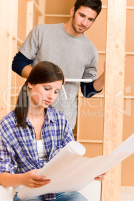 Home improvement young couple with blueprints