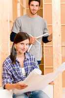 Home improvement young couple with blueprints