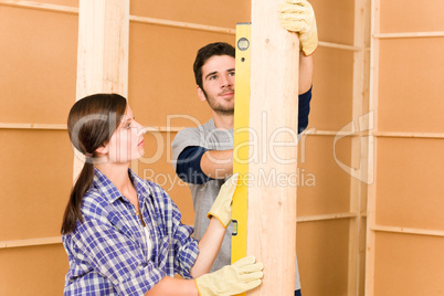 Home improvement smiling couple with spirit level