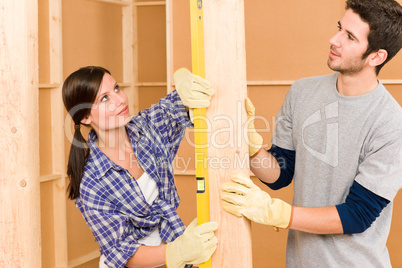 Home improvement smiling couple with spirit level