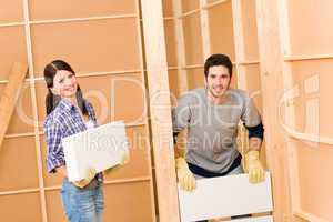 Home improvement young couple building brick wall