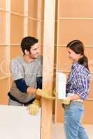 Home improvement young couple building brick wall