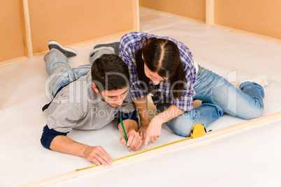 Home improvement young couple measure with rule