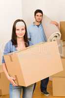 Home moving young couple boxes and carpet