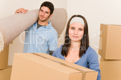 Home moving young couple boxes and carpet