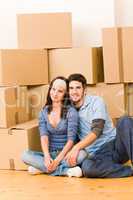 Moving new home young couple sitting floor