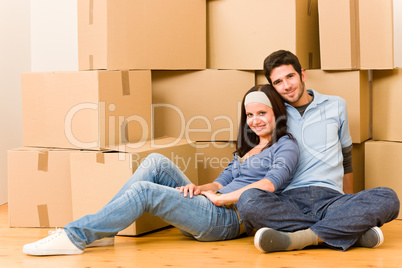 Moving new home young couple sitting floor
