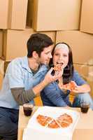 Moving new home young couple eat pizza