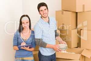 Moving home young happy couple unpacking boxes