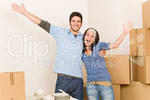 Young cheerful couple moving into new home