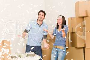 Move home cheerful couple throw Styrofoam peanuts