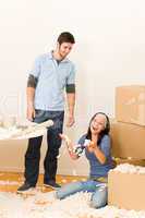 Young cheerful couple moving into new home