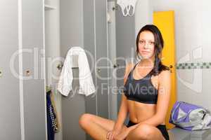 Locker room young sportive woman sitting smiling