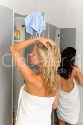 Locker room two relaxed women wrapped towel