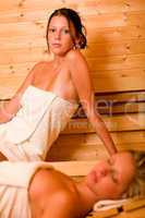 Sauna two women relaxing sweating covered towel