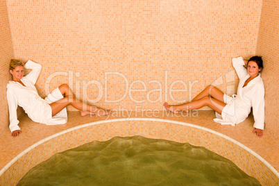 Relax spa pool two women sitting bathrobe