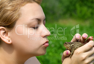 woman kissing a toad