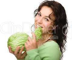 Beautiful young girl with green cabbage